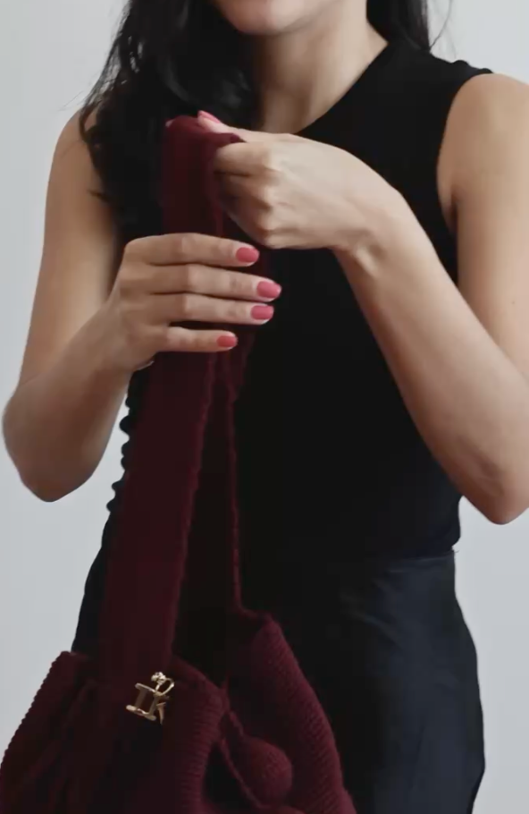La Canasta Bag in burgundy by iiwa kashi, handcrafted by Wayuu artisans in Venezuela with cotton and caña brava, featuring 24K gold-plated logo.