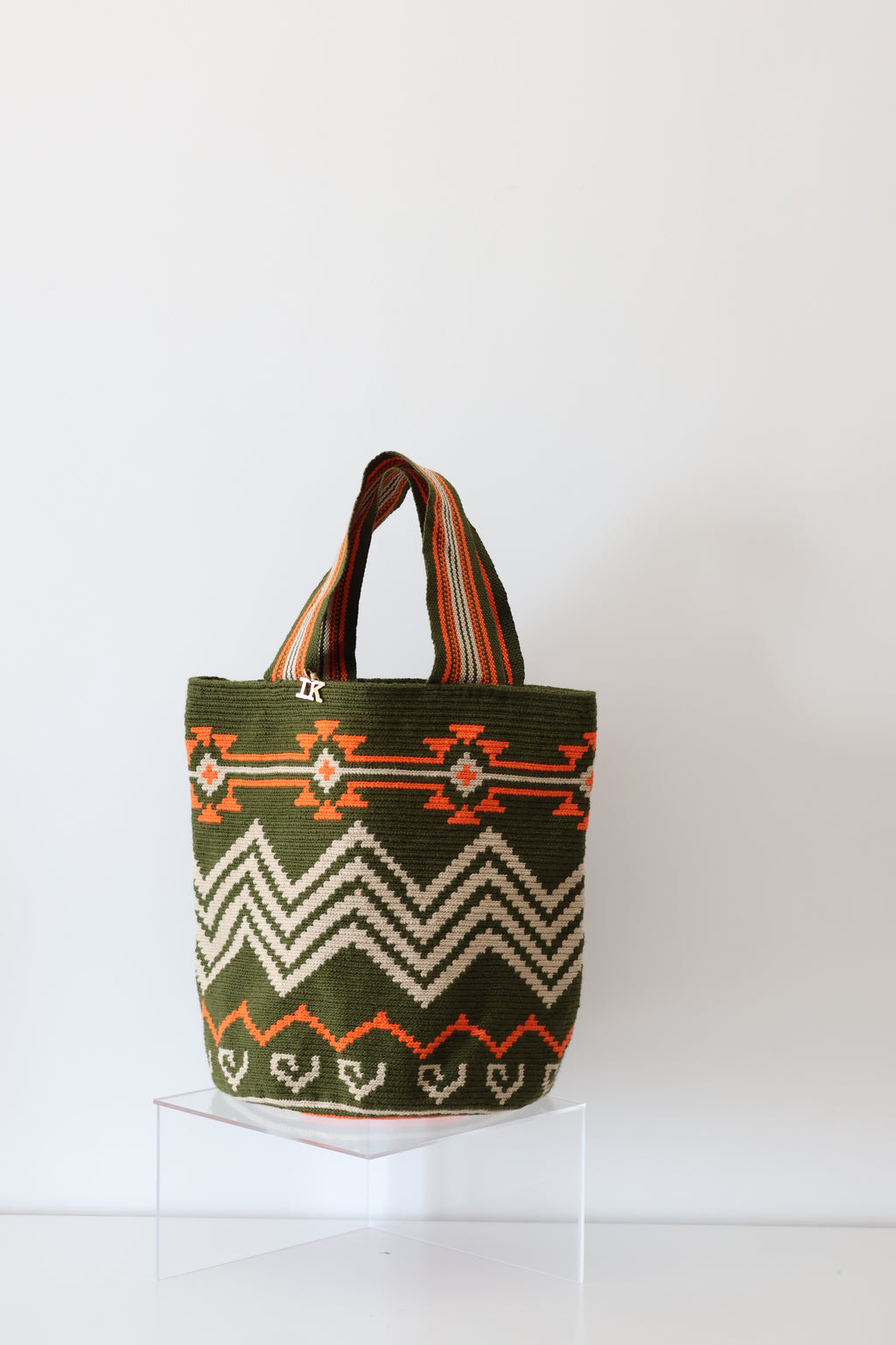 PALANACHI de la Tierra Wayuu Tote Bag in green and orange by iiwa kashi, handcrafted by Wayuu artisans from La Guajira, Venezuela, made with pure cotton and 24K gold-plated silver logo.